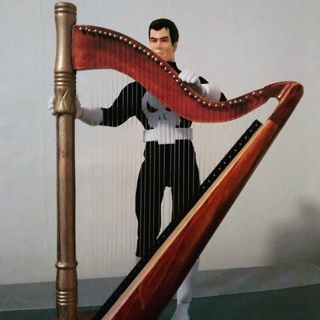 Punisher posing behind his harp.