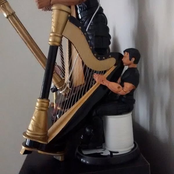 Thomas Jane relaxing by his harp.