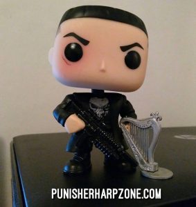 He's trying out on a small harp he borrowed from a small Punisher figure. Soon I'll have to get for him a harp of his own.