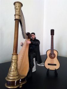 Jon-Bernthal-as-The-Punisher-playing-his-harp-with-his-guitar-by-his-side.